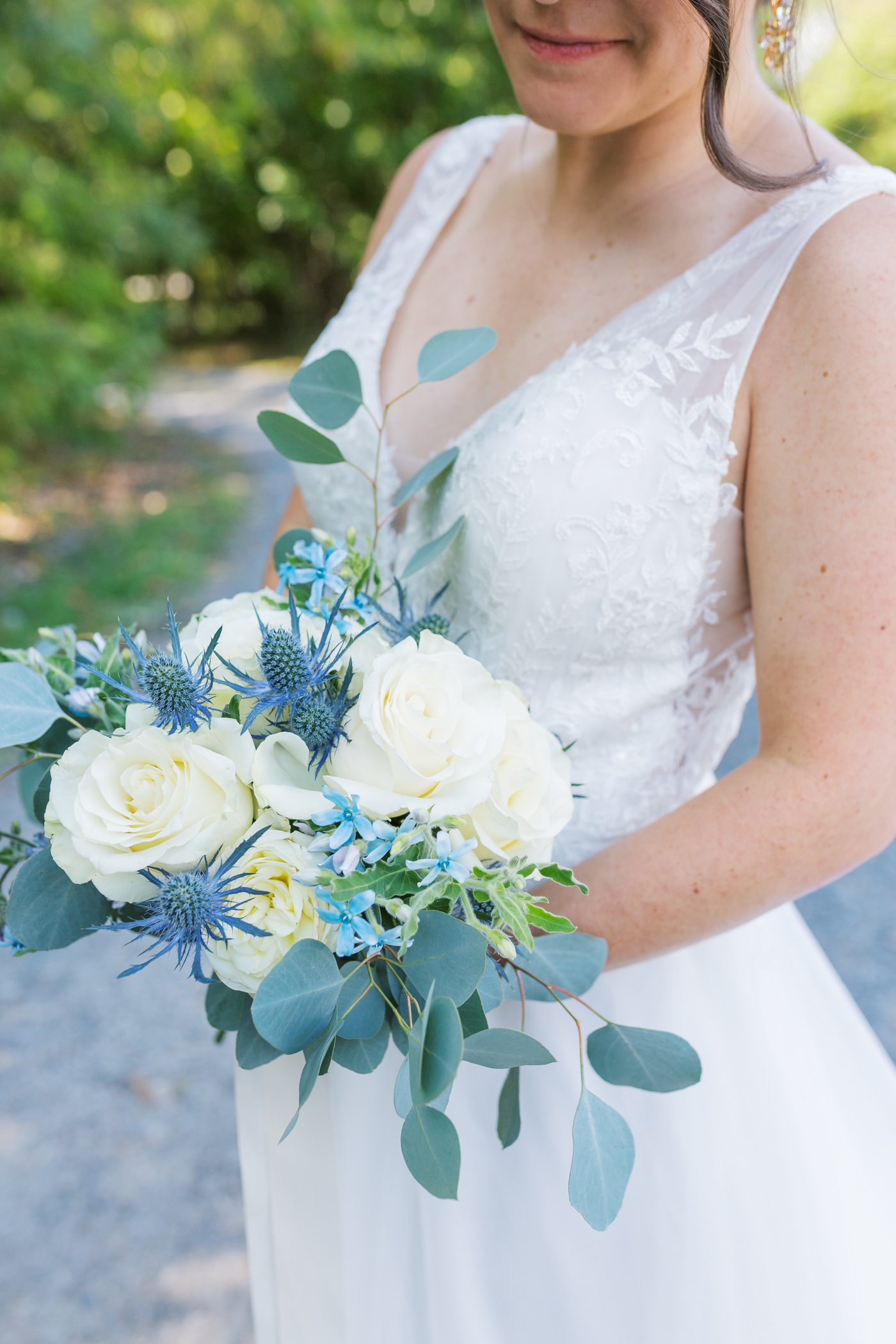 Bridal bouquet with eucalyptus, blue thistle and white roses